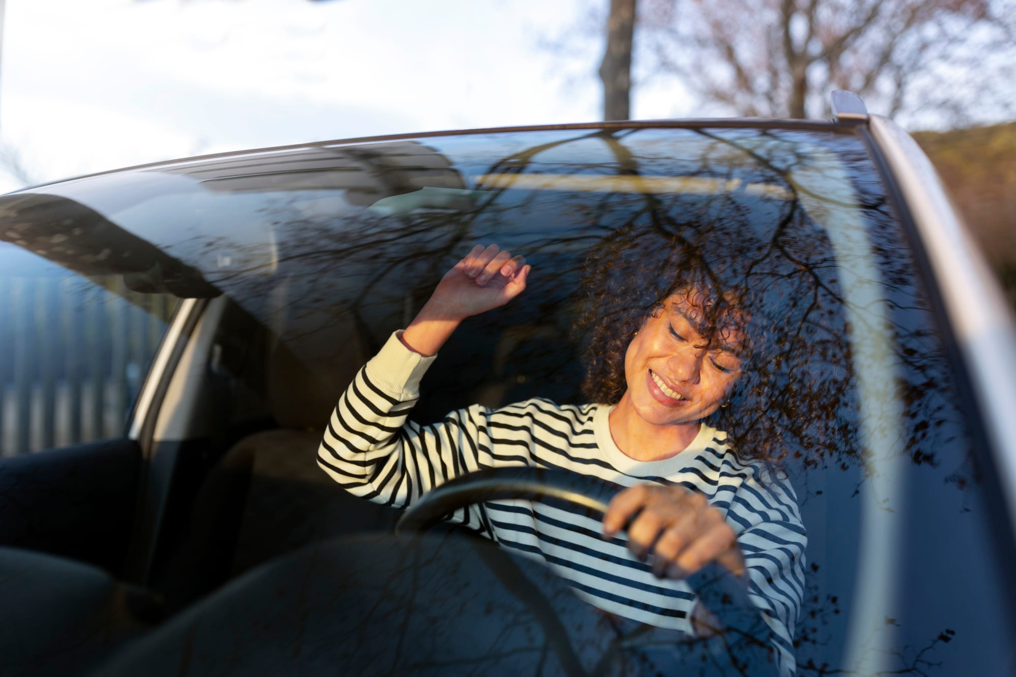 Student smiling out of a car window